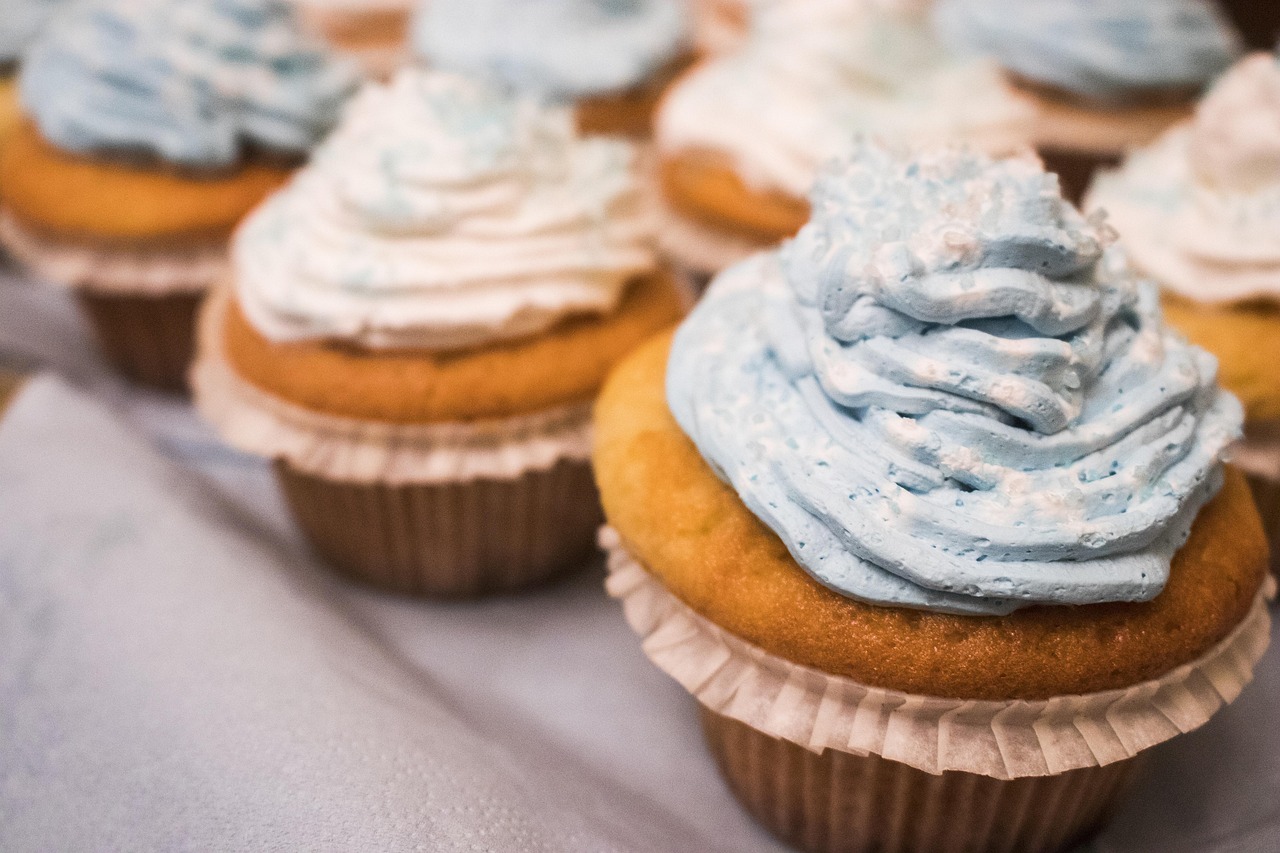 Cupcakes com cobertura azul-clara e branca para festa de unicórnio
